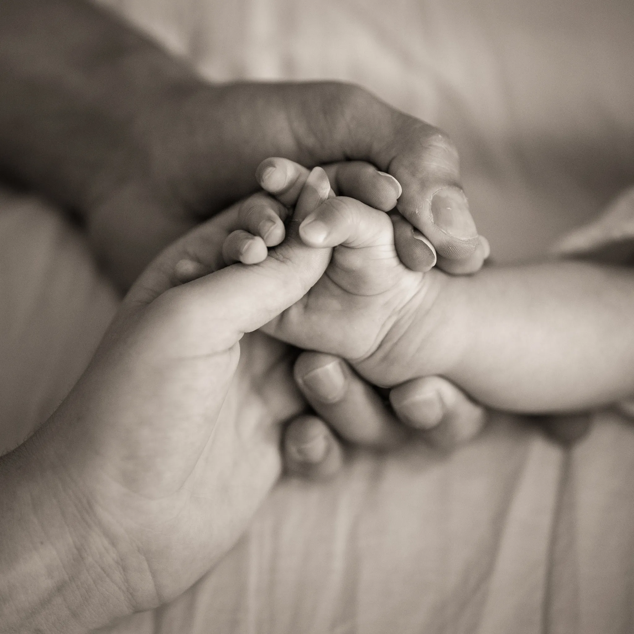mains enlacées parents et bébé